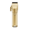A gold-colored BabylissPro FXONE cordless hair clipper with a metallic finish and a black rubber grip.