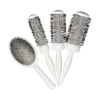 Set of four white hairbrushes with black bristle patterns on a white background