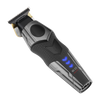 A cordless electric hair trimmer shown at a diagonal angle on a solid white background. The clipper features a black and dark gray textured handle with a circular power button, a black cutting head with gold-colored blades, and illuminated blue LED indicator lights on the side.