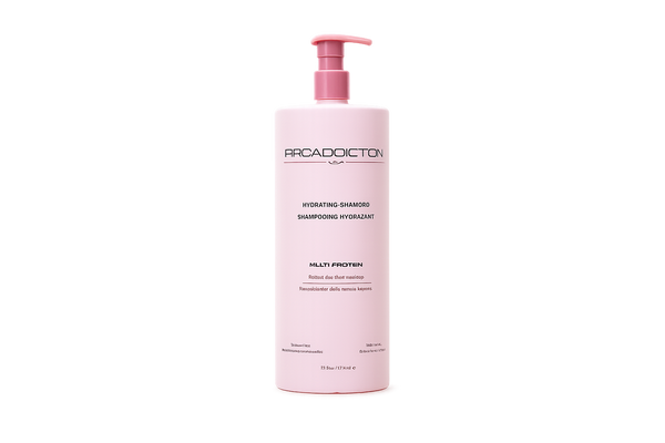 A pink bottle of Pracadoiction Hydrating Shampoo with a matching pink pump dispenser, centered on a plain white background.