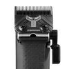 A close-up studio shot of a black cordless hair clipper head showing the blade assembly, textured handle grip, and side release lever against a solid white background.