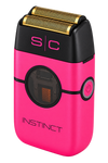 A pink and black portable electric shaver with gold-colored shaving blades, featuring the brand name 'INSTINCT' and 'S|C' on the front, set against a plain white background.