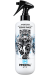 A white spray bottle of Immortal NYC Aventura Original Eau de Cologne Reserve Familia, featuring a graphic of a snow leopard with blue eyes and black spots, on a solid white background.