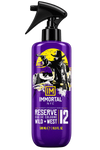 A 500 ml spray bottle of Immortal NYC Reserve Eau de Cologne Wild + West, featuring a vibrant purple body with a black trigger sprayer and a graphic label of a cowboy silhouette against a yellow moon.