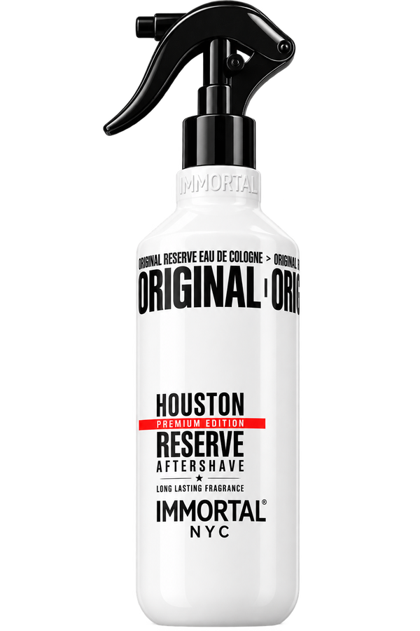 A white spray bottle of Immortal NYC Original Reserve Aftershave in the Houston scent, featuring a black trigger spray top and bold black text with a red accent stripe on the label.