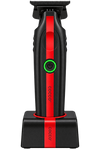 A black cordless hair clipper with a vertical red accent stripe and a glowing green power button, shown standing on its matching black charging base against a plain white background. The brand name 'cocoo' is printed vertically on both the clipper and the base.