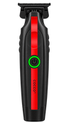 A cordless hair trimmer shown vertically against a solid white background. The trimmer has a black body with a prominent red vertical stripe down the center, a green power button with a glowing green ring, and the brand name 'cocco' printed vertically in black near the bottom.