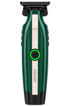 A Cocco electric hair trimmer shown from the front on a solid white background. The clipper features a dark green body with a vertical cream-colored stripe, a black power button with a glowing green ring, and a black metal cutting head.