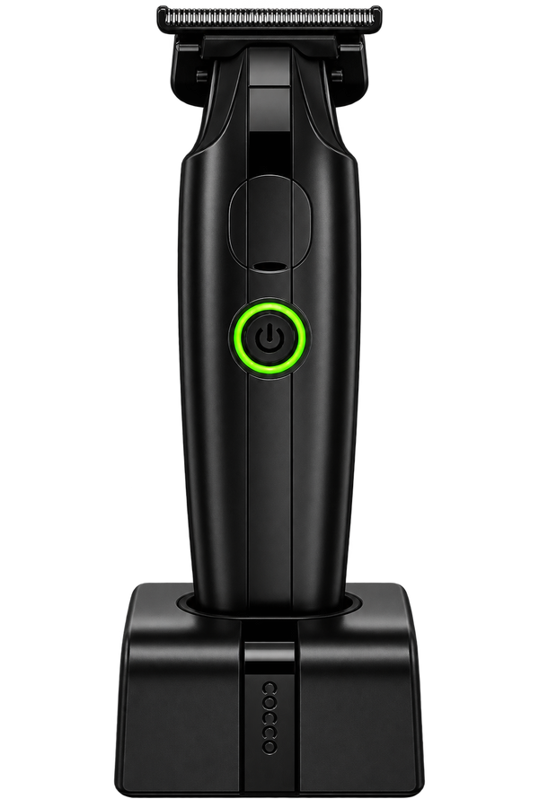Black electric shaver with a green illuminated power button, shown upright on its matching charging dock against a solid white background.