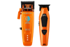 Two orange cordless hair clippers shown side by side on a plain white background. The left clipper is labeled SABER II and features a blue circular graphic with the words 'DIGITAL BRIGHTNESS'; the right clipper is labeled JRL.