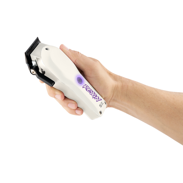 Hand holding a white grooming clipper with visible brand name on a white background