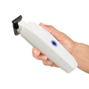 Hand holding a white handheld device with a black blade on a white background