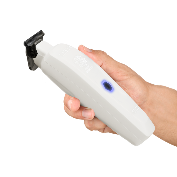 Hand holding a white handheld device with a black blade on a white background