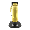 Gold hair clipper with black accents on a white background