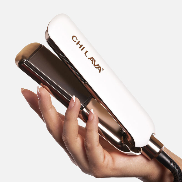 Hair straightener with 'CHI LAVA' branding held by a hand on a white background