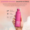 Pink bottle of OliG hair care product held in a hand with promotional text on a pink background