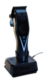 Black Wahl vapor switch cordless clipper standing on a matching black charging dock against a white background.